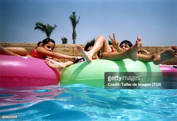 Childrends enjoying in swimming pool .