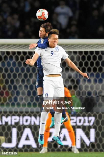 Kim Shinwook of South Korea and Genta Miura of Japan compete for the ball during the EAFF E-1 Men's Football Championship between Japan and South...