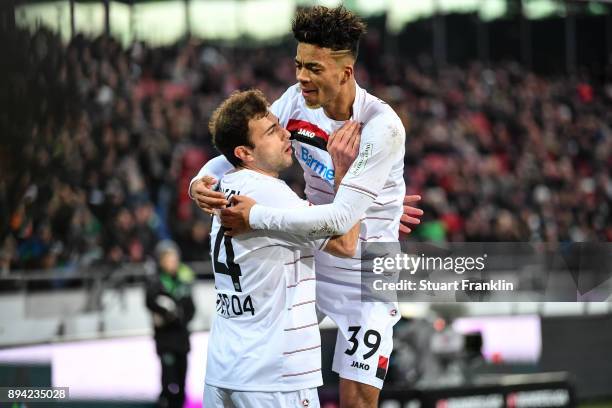 Admir Mehmedi of Bayer Leverkusen celebrates with Benjamin Henrichs of Bayer Leverkusen after scoring his team's equalizing goal to make it 2-2...