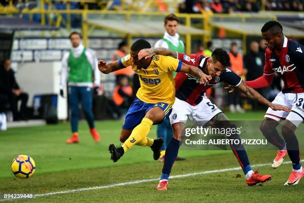 Juventus's forward from Brazil Douglas Costa fights for the ball with Bologna's defender Erick Pulgar from Chile during the Italian Serie A football...