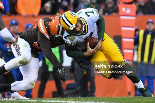 Quarterback Brett Hundley of the Green Bay Packers carries the ball as he is hit by linebacker Christian Kirksey of the Cleveland Browns in the...