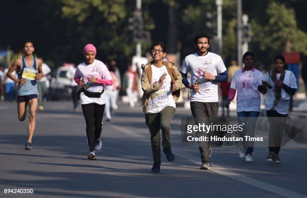 Participants take part in Run for Laadli, a half marathon to stop crimes against women, at JLN Stadium, on December 17, 2017 in New Delhi, India. A...