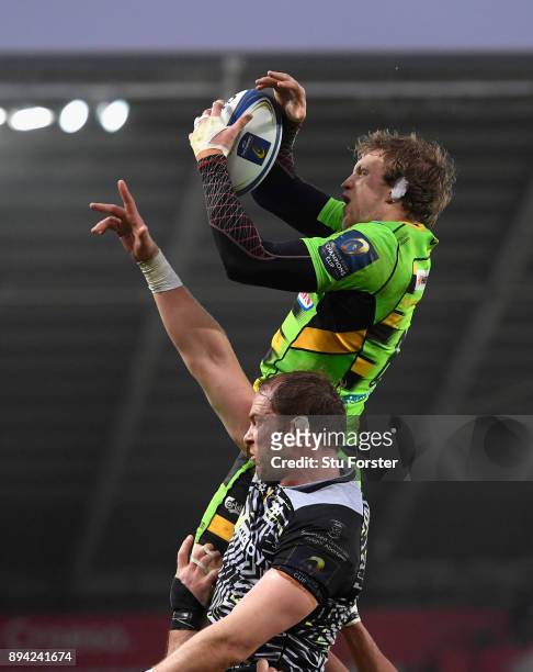 Sainst player Jamie Gibson outjumps Alun Wyn Jones in the lineout during the European Rugby Champions Cup match between Ospreys and Northampton...