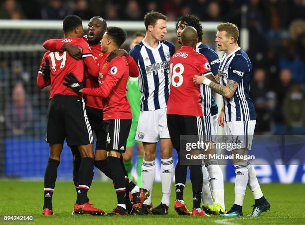 Romelu Lukaku of Manchester United and teammate Jesse Lingard hold back Marcus Rashford during a confrontation with Ahmed El-Sayed Hegazi of West...
