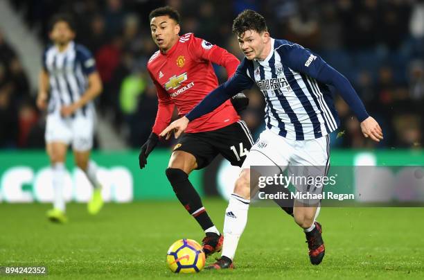Oliver Burke of West Bromwich Albion runs with the ball away from Jesse Lingard of Manchester United during the Premier League match between West...