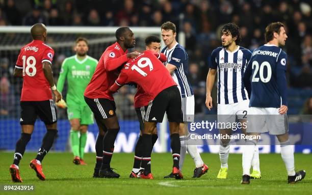 Jonny Evans of West Bromwich Albion, Romelu Lukaku of Manchester United and teammate Jesse Lingard hold back Marcus Rashford during a confrontation...