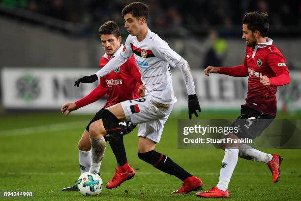 Edgar Prib of Hannover 96 , Kai Havertz of Bayer Leverkusen and Julian Korb of Hannover 96 battle for the ball during the Bundesliga match between...