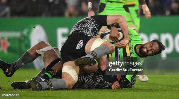 Saints wing Ahsee Tuala is stopped by the Ospreys defence during the European Rugby Champions Cup match between Ospreys and Northampton Saints at...