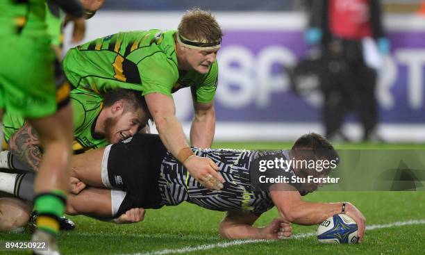 Ospreys player Rhys Webb dives over to score the second Ospreys try during the European Rugby Champions Cup match between Ospreys and Northampton...