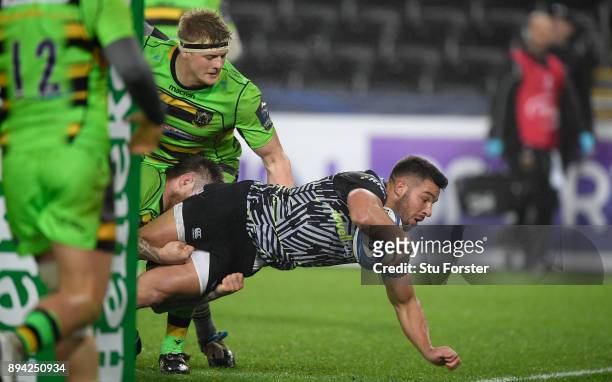 Ospreys player Rhys Webb dives over to score the second Ospreys try during the European Rugby Champions Cup match between Ospreys and Northampton...
