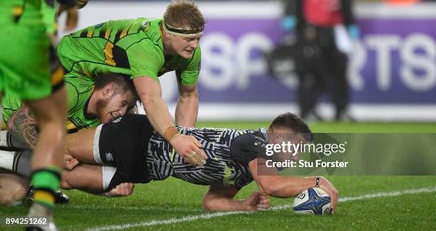 Ospreys player Rhys Webb dives over to score the second Ospreys try during the European Rugby Champions Cup match between Ospreys and Northampton...