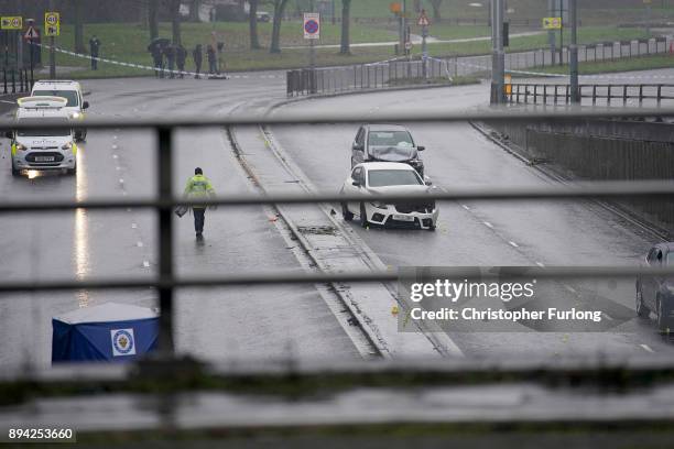 Police officers work at the scene of a multi-vehicle crash on Lee Bank Middleway, Edgbaston, in Birmingham, which left six people dead and a seventh...