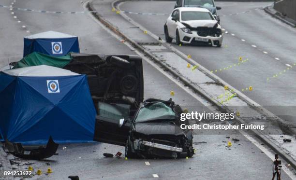 Police officers work at the scene of a multi-vehicle crash on Lee Bank Middleway, Edgbaston, in Birmingham, which left six people dead and a seventh...