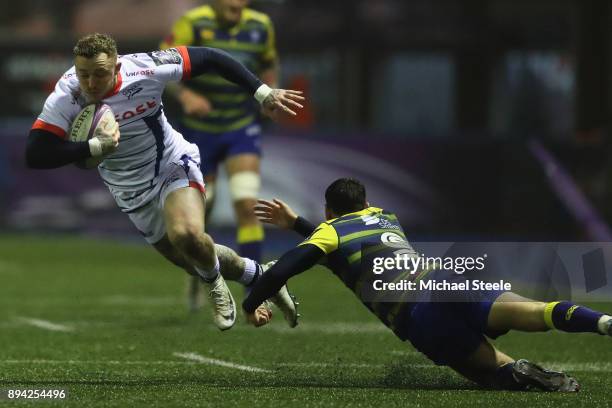 Josh Charnley of Sale evades the challenge of Tomos Williams of Cardiff during the European Rugby Challenge Cup Pool Two match between Cardiff Blues...