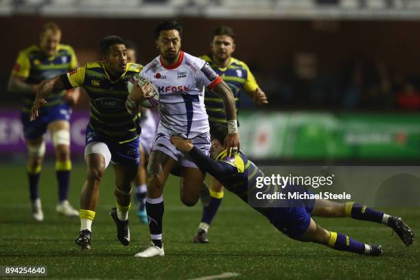 Denny Solomona of Sale is tackled by Tomos Williams of Cardiff as Rey Lee-Lo chases down during the European Rugby Challenge Cup Pool Two match...