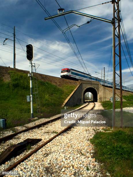 Suburban crossing a tunnel and railways.