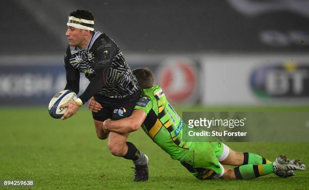 Ospreys centre Kieron Fonotia offloads despitre the attentions of Piers Francis during the European Rugby Champions Cup match between Ospreys and...