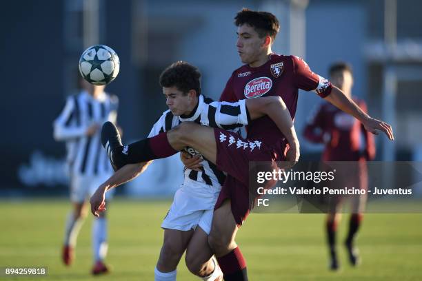 Carmine Sterrantino of Juventus U16 is challenged during the match between Juventus U16 and Torino FC U16 at Juventus Center Vinovo on December 17,...