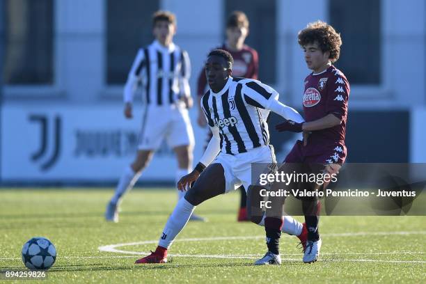 Franco Tongya of Juventus U16 is challenged during the match between Juventus U16 and Torino FC U16 at Juventus Center Vinovo on December 17, 2017 in...