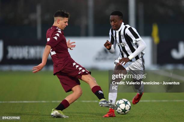 Franco Tongya of Juventus U16 is challenged during the match between Juventus U16 and Torino FC U16 at Juventus Center Vinovo on December 17, 2017 in...