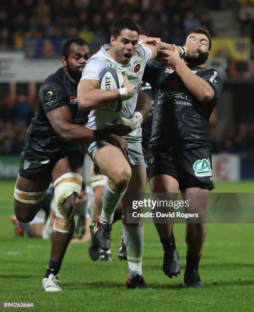 Sean Maitland of Saracens holds off Peceli Yato and Rabah Slimani during the European Rugby Champions Cup match between ASM Clermont Auvergne and...