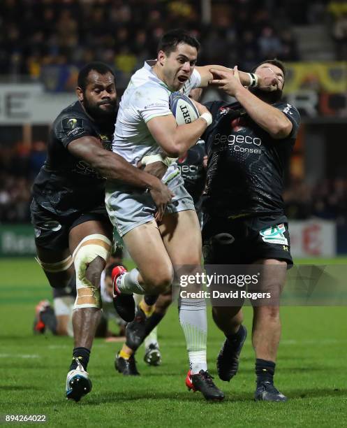 Sean Maitland of Saracens holds off Peceli Yato and Rabah Slimani during the European Rugby Champions Cup match between ASM Clermont Auvergne and...