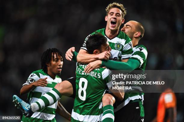 Sporting's Portuguese midfielder Bruno Fernandes celebrates with Sporting's Dutch forward Bas Dost and Sporting's forward Daniel Podence after...
