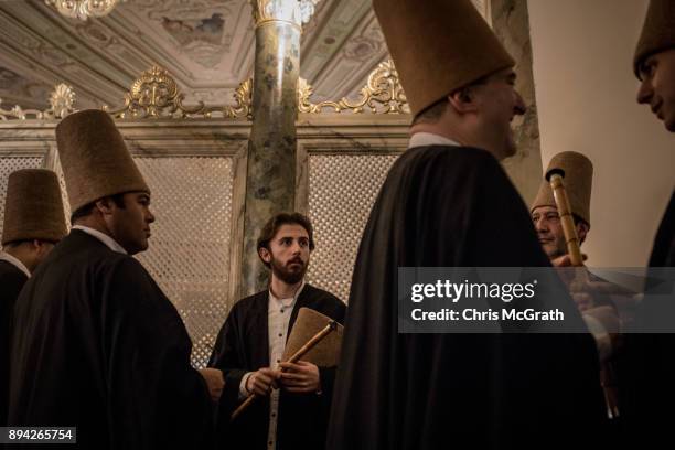 Whirling Dervishes prepare before taking part in a Sema Prayer Ceremony marking the anniversary of the death of Mevlana Jalal al-Din al-Rumi on...