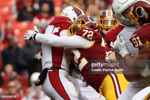 Quarterback Blaine Gabbert of the Arizona Cardinals is sacked by offensive tackle Kevin Bowen of the Washington Redskins in the first quarter against...