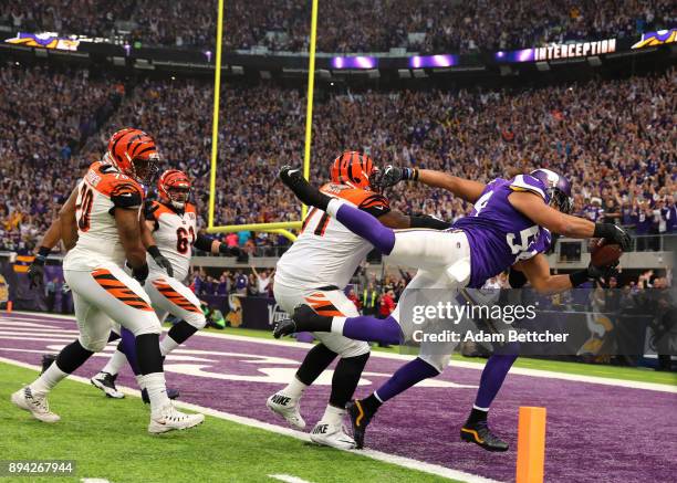 Eric Kendricks of the Minnesota Vikings dives with the ball for a touchdown after intercepting Andy Dalton of the Cincinnati Bengals in the first...