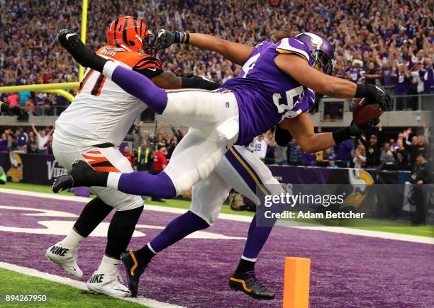 Eric Kendricks of the Minnesota Vikings dives with the ball for a touchdown after intercepting Andy Dalton of the Cincinnati Bengals in the first...