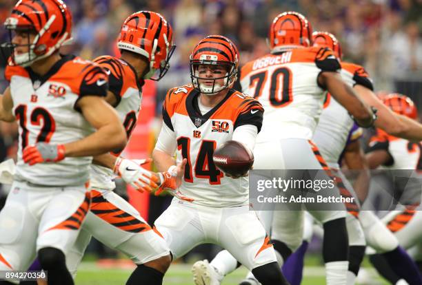Andy Dalton of the Cincinnati Bengals hands the ball off to Josh Malone in the first quarter of the game against the Minnesota Vikings on December...