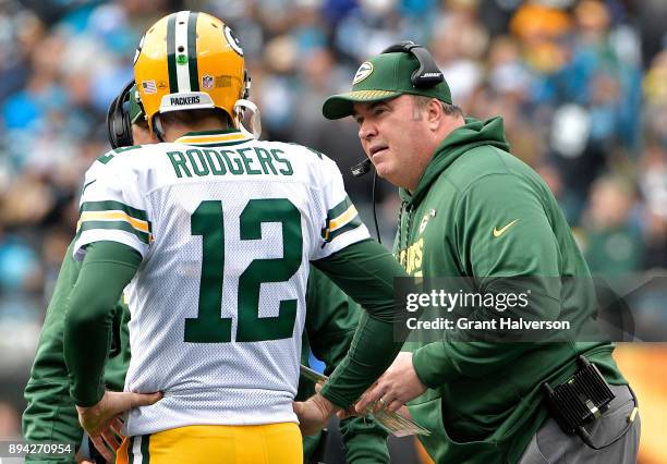 Head coach Mike McCarthy talks to Aaron Rodgers of the Green Bay Packers in the second quarter against the Carolina Panthers at Bank of America...