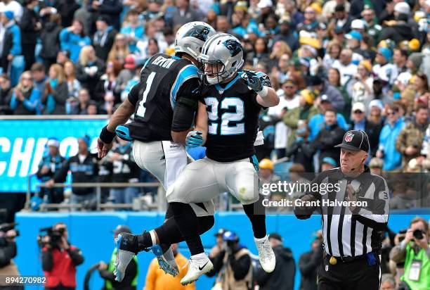 Christian McCaffrey celebrates with teammate Cam Newton of the Carolina Panthers after a touchdown against the Green Bay Packers in the first quarter...