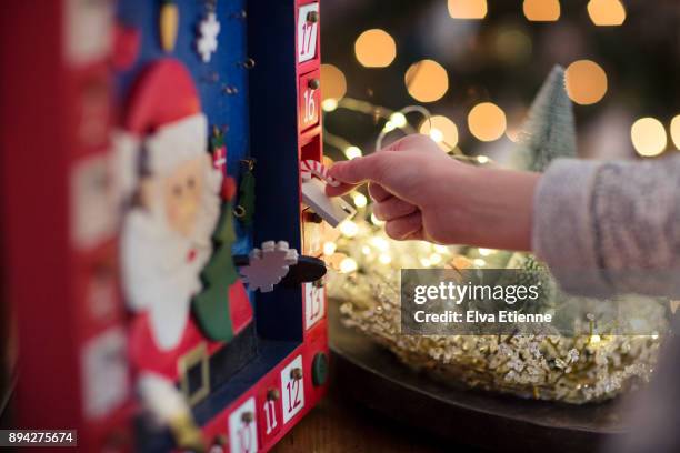 child opening christmas advent calendar - christmas calendar stock-fotos und bilder