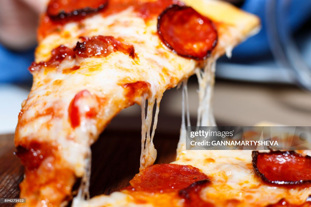 Closeup of a piece of pepperoni pizza. Italian pizza.