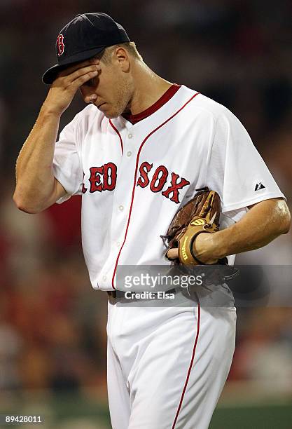 Jonathan Papelbon of the Boston Red Sox heads to the dugout after an error in the ninth inning against the Oakland Athletics at Fenway Park July 28,...