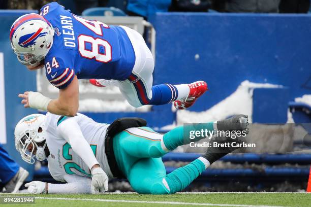 Nick O'Leary of the Buffalo Bills is tackled by T.J. McDonald of the Miami Dolphins during the first quarter on December 17, 2017 at New Era Field in...