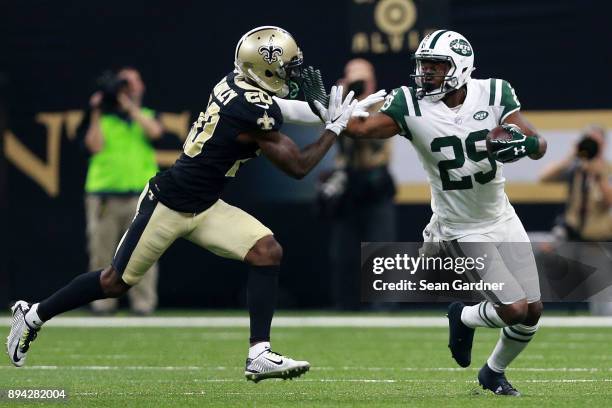 Running back Bilal Powell of the New York Jets runs with the ball as cornerback Ken Crawley of the New Orleans Saints defends during the first half...