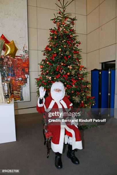 Santa Claus - Le Pere Noel" poses with a Christmas Tree during the 32th "Reve d'Enfants" : Charity Gala at Opera Bastille on December 17, 2017 in...