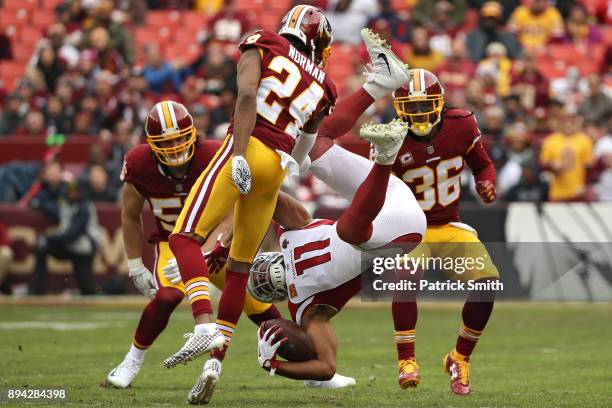 Wide receiver Larry Fitzgerald of the Arizona Cardinals is tackled by cornerback Josh Norman of the Washington Redskins during the first quarter at...