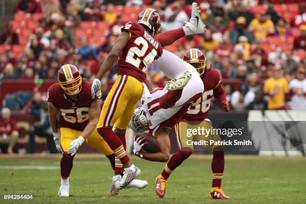 Wide receiver Larry Fitzgerald of the Arizona Cardinals is tackled by cornerback Josh Norman of the Washington Redskins during the first quarter at...