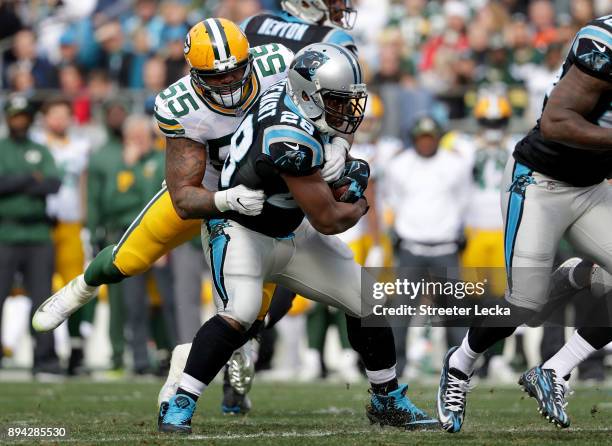 Jonathan Stewart of the Carolina Panthers runs the ball against Ahmad Brooks of the Green Bay Packers in the second quarter during their game at Bank...