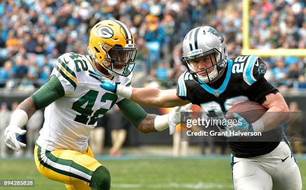 Christian McCaffrey of the Carolina Panthers runs against Aaron Ripkowski of the Green Bay Packers during their game at Bank of America Stadium on...