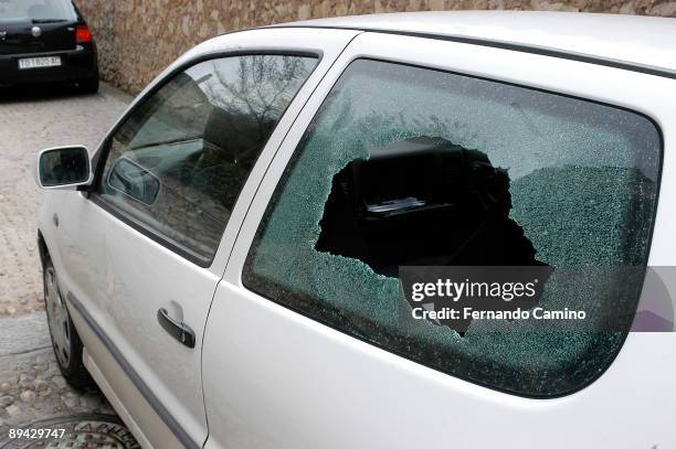 Broken window of automovil by presumed delinquents in Cuenca, Spain.