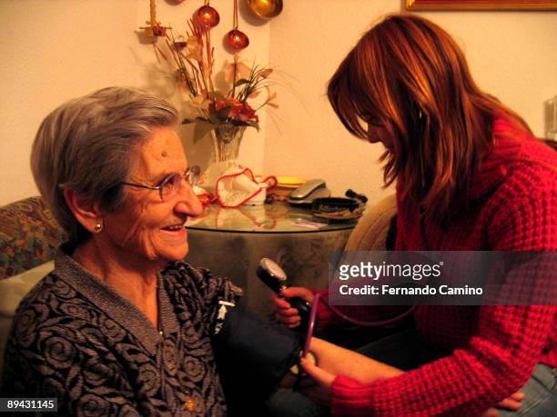 Family doctor taking the blood pressurein a home visit.