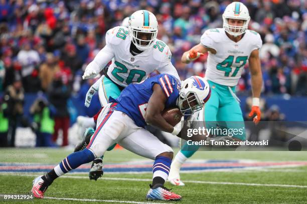 Reshad Jones of the Miami Dolphins attempts to tackle LeSean McCoy of the Buffalo Bills during the first quarter on December 17, 2017 at New Era...