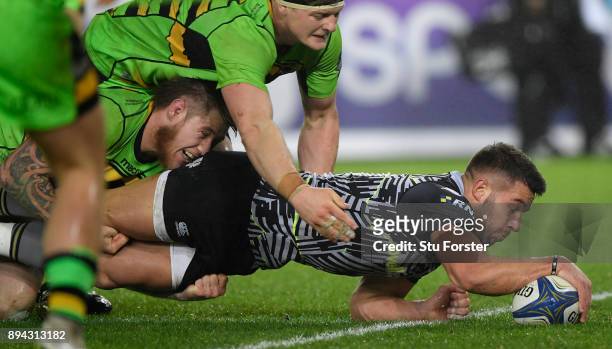 Ospreys player Rhys Webb dives over to score the second Ospreys try during the European Rugby Champions Cup match between Ospreys and Northampton...