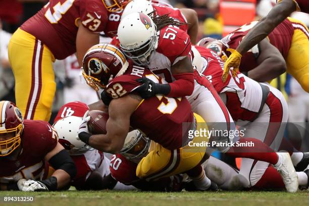Running Back Samaje Perine of the Washington Redskins is tackled by linebacker Josh Bynes of the Arizona Cardinals in the second quarter at FedEx...