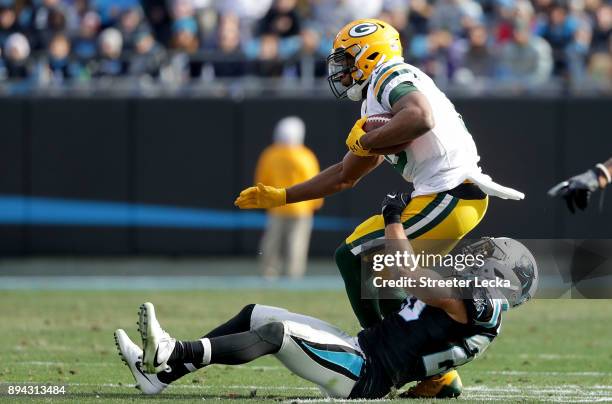 Kurt Coleman of the Carolina Panthers tackles Randall Cobb of the Green Bay Packers in the third quarter during their game at Bank of America Stadium...